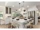 White kitchen with center island, stainless steel appliances, and pendant lighting at 7489 E Windrose Dr, Scottsdale, AZ 85260