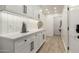 Bright laundry room with white cabinets and quartz countertops at 7489 E Windrose Dr, Scottsdale, AZ 85260