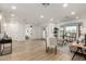 Spacious living room with hardwood floors, a modern sofa, and a view into the entryway at 7489 E Windrose Dr, Scottsdale, AZ 85260