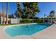 Inviting kidney-shaped pool with a large patio and lush landscaping at 7489 E Windrose Dr, Scottsdale, AZ 85260