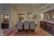 Formal dining room showcasing a dark wood table and elegant chairs at 7546 E High Point Dr, Scottsdale, AZ 85266