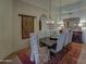 Formal dining room with a large table, chandelier, and ornate rug at 7546 E High Point Dr, Scottsdale, AZ 85266