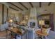 Living room with fireplace, high ceilings, and wood beams at 7546 E High Point Dr, Scottsdale, AZ 85266