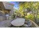 Outdoor dining patio with seating and built-in grill at 7546 E High Point Dr, Scottsdale, AZ 85266