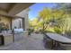 Outdoor patio with a built-in grill and seating area at 7546 E High Point Dr, Scottsdale, AZ 85266