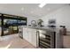 Modern kitchen island with wine cooler and white cabinetry at 8443 E Bonita Dr, Scottsdale, AZ 85250