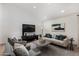 Light and airy living room with comfortable seating and large TV at 8443 E Bonita Dr, Scottsdale, AZ 85250