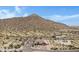 Aerial view of a house nestled in a desert landscape near mountains at 8474 W Switchback Trl, Casa Grande, AZ 85194