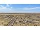 Aerial view of a house in a desert landscape, with a road and distant town at 8474 W Switchback Trl, Casa Grande, AZ 85194