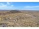 Aerial view of a desert landscape with distant mountains and several houses at 8474 W Switchback Trl, Casa Grande, AZ 85194