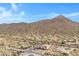 Aerial view of a house and desert landscape with mountains in the background at 8474 W Switchback Trl, Casa Grande, AZ 85194