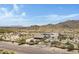 Aerial view of a house with a large yard in a desert setting, near mountains at 8474 W Switchback Trl, Casa Grande, AZ 85194