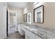 Double vanity bathroom with granite countertops and modern mirrors at 8474 W Switchback Trl, Casa Grande, AZ 85194