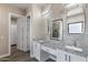 Double vanity bathroom with granite countertops and large mirrors at 8474 W Switchback Trl, Casa Grande, AZ 85194