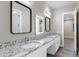 Double vanity bathroom with granite countertops and modern mirrors at 8474 W Switchback Trl, Casa Grande, AZ 85194