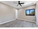 Bedroom with wood-look floors, ceiling fan and window at 8474 W Switchback Trl, Casa Grande, AZ 85194