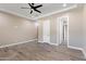 Bright bedroom featuring wood-look floors and ceiling fan at 8474 W Switchback Trl, Casa Grande, AZ 85194