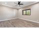 Spacious bedroom with wood-look tile floors and large window at 8474 W Switchback Trl, Casa Grande, AZ 85194