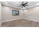 Simple bedroom with wood-look floors and ceiling fan at 8474 W Switchback Trl, Casa Grande, AZ 85194