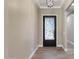 Spacious entryway with modern light fixture and tile floor at 8474 W Switchback Trl, Casa Grande, AZ 85194