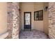 Inviting entryway with an iron door and stone detailing at 8474 W Switchback Trl, Casa Grande, AZ 85194