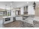 Modern kitchen with island, white cabinets, and granite countertops at 8474 W Switchback Trl, Casa Grande, AZ 85194