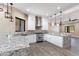 Spacious kitchen with island, white cabinets and granite countertops at 8474 W Switchback Trl, Casa Grande, AZ 85194