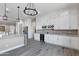 Modern kitchen with white cabinets, granite counters and wine cooler at 8474 W Switchback Trl, Casa Grande, AZ 85194