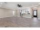 Open living room with kitchen view, featuring tile floors and modern ceiling fan at 8474 W Switchback Trl, Casa Grande, AZ 85194