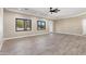 Open living space with wood-look tile floors and ceiling fan at 8474 W Switchback Trl, Casa Grande, AZ 85194