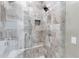 Walk-in shower with stone tile and multiple shower heads at 8474 W Switchback Trl, Casa Grande, AZ 85194