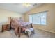 Bedroom with a wooden bed frame and large window at 896 E Windsor Dr, Gilbert, AZ 85296