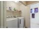 Laundry room with washer, dryer, and storage shelves at 896 E Windsor Dr, Gilbert, AZ 85296