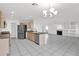 Open-concept kitchen with stainless steel appliances overlooking the living area with a fireplace at 914 E Ross Ave, Phoenix, AZ 85024