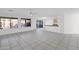 Bright living room featuring tile floors, windows overlooking a pool, and an open kitchen at 914 E Ross Ave, Phoenix, AZ 85024