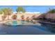 Pool with decorative rock landscaping against a brick wall at 914 E Ross Ave, Phoenix, AZ 85024