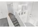 Bright staircase with a modern chandelier and neutral carpet, leading to the upper level at 914 E Ross Ave, Phoenix, AZ 85024