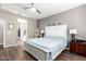 Main bedroom with large bed, dresser, and ceiling fan at 1081 W Danish Red Trl, San Tan Valley, AZ 85143