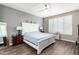 Main bedroom with a large bed and a view into the attached bathroom at 1081 W Danish Red Trl, San Tan Valley, AZ 85143