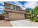 Two-story house with a two-car garage and landscaped yard at 1081 W Danish Red Trl, San Tan Valley, AZ 85143