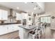 Modern kitchen with white cabinets, stainless steel appliances, and a large island at 1081 W Danish Red Trl, San Tan Valley, AZ 85143