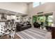 Bright living room with high ceilings, sliding glass doors, and hardwood floors at 1081 W Danish Red Trl, San Tan Valley, AZ 85143