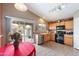 Kitchen with wood cabinets, black appliances, and access to the backyard at 1107 E Lakeview Dr, San Tan Valley, AZ 85143