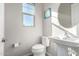 Clean bathroom with pedestal sink, toilet, and large mirror at 1110 S Jay St, Chandler, AZ 85286