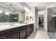 Elegant bathroom with double sinks, large shower, and walk-in closet at 1110 S Jay St, Chandler, AZ 85286