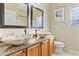 Elegant bathroom featuring dual vessel sinks, granite countertops, and stylish fixtures for a spa-like experience at 1242 E Bartlett Way, Chandler, AZ 85249