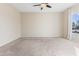 Comfortable carpeted bedroom with a ceiling fan, natural light, and ample space for relaxation at 1242 E Bartlett Way, Chandler, AZ 85249