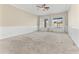 Large bedroom with neutral carpet, ceiling fan, wainscoting, and dual windows providing lots of natural light at 1242 E Bartlett Way, Chandler, AZ 85249