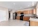 Bright kitchen features stainless steel refrigerator and black appliances with tile floors at 1242 E Bartlett Way, Chandler, AZ 85249