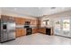 Bright kitchen with stainless refrigerator, black appliances, and doors leading to backyard at 1242 E Bartlett Way, Chandler, AZ 85249